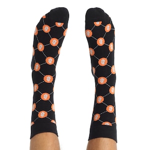 May include: A pair of black socks with a repeating pattern of orange Bitcoin symbols on a black background.