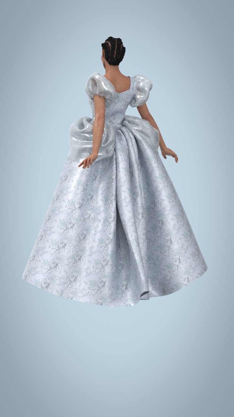 May include: A woman wearing a white gown with a floral pattern. The gown has a fitted bodice and a full skirt. The woman is standing with her back to the camera.
