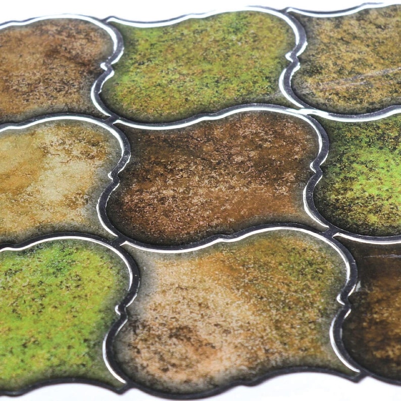 3D peel-and-stick wall tile grid with scalloped square tiles in moss green, brown, and tan for an earthy kitchen backsplash.