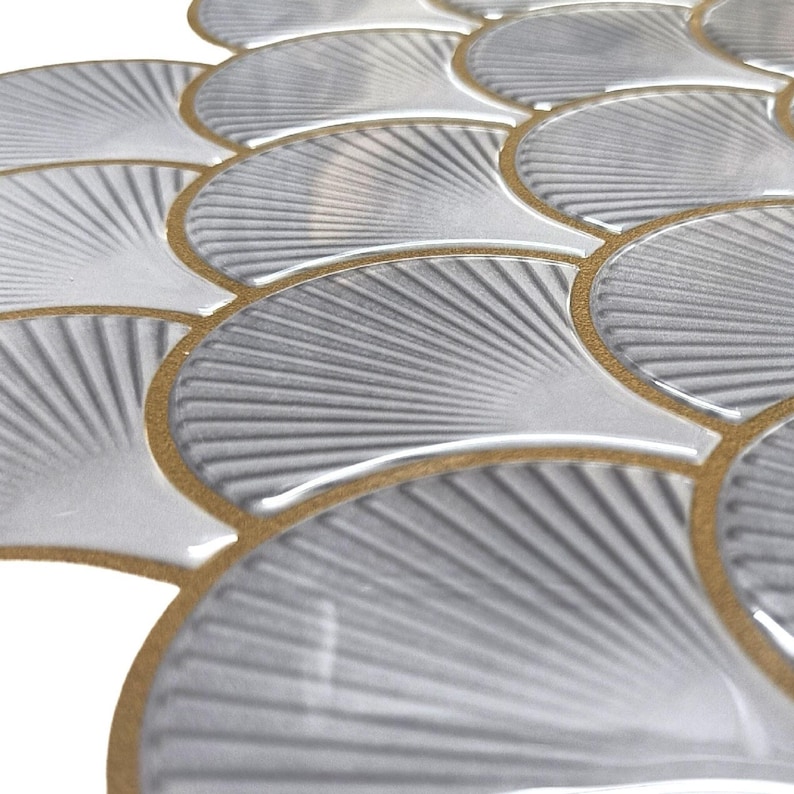 White 3D peel-and-stick tile with gold-edged scallop pattern, perfect kitchen backsplash and wall decor.