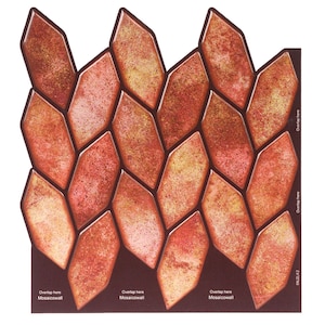 May include: A sheet of red and gold mosaic tiles in a diamond pattern. The tiles are designed to be overlapped when installed. The sheet is labeled "Mosaicwall" and has instructions for installation.