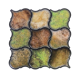 3D peel-and-stick wall tile grid with scalloped square tiles in moss green, brown, and tan for an earthy kitchen backsplash.