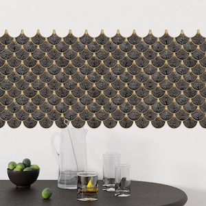 Black Egyptian peel-and-stick tile set in overlapping scallop shapes with tan borders for a 3D vinyl backsplash.
