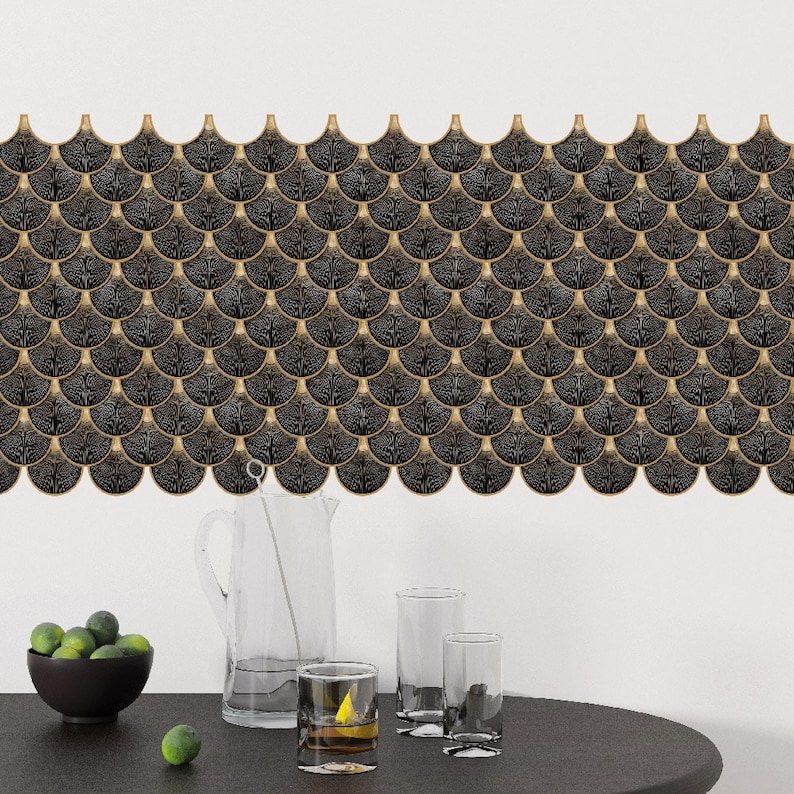 Black Egyptian peel-and-stick tile set in overlapping scallop shapes with tan borders for a 3D vinyl backsplash.