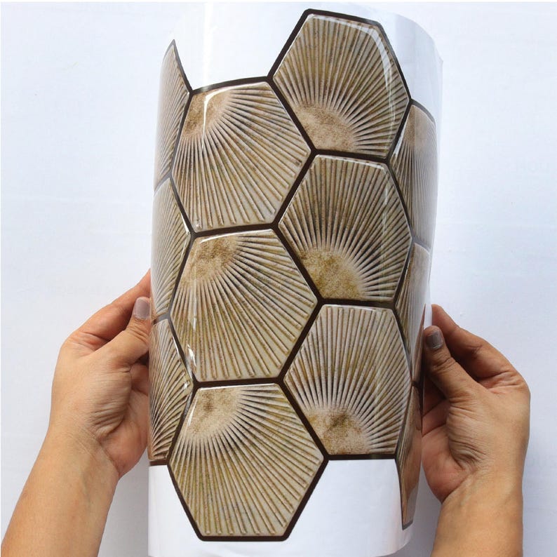 Light brown hexagon peel-and-stick tile sheet for kitchen backsplash; wood-look honeycomb pattern, self-adhesive vinyl tile.