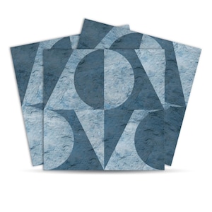May include: A stack of square tiles with a geometric design. The tiles feature a textured, stone-like appearance in shades of blue and white. The design includes circles, triangles, and squares, creating a modern, abstract pattern.