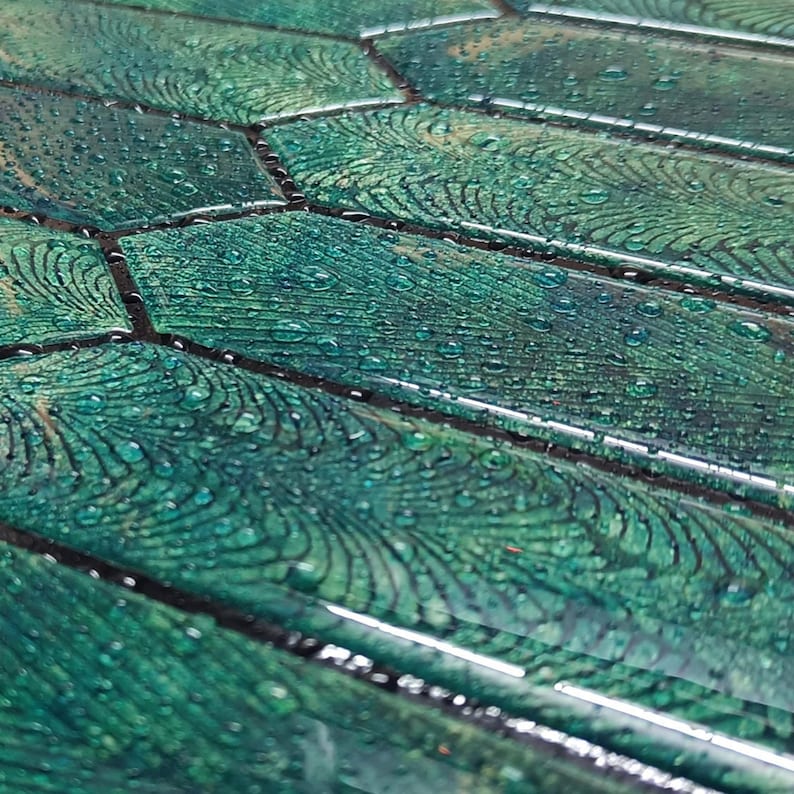 Angled close shot showing printed darker grout lines and glossy 3D picket texture on green peel and stick wall tiles