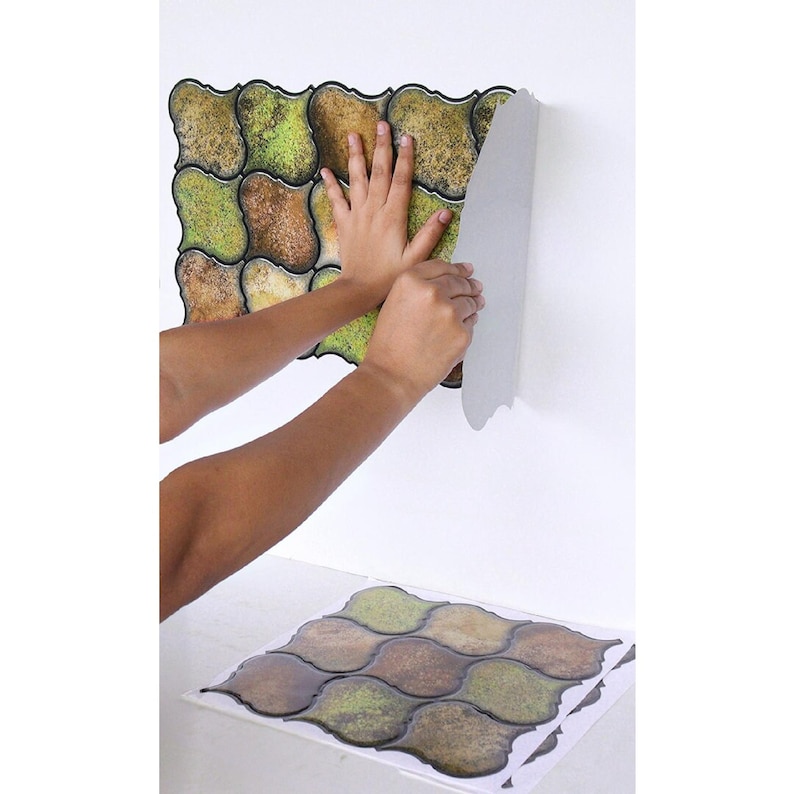 3D peel-and-stick wall tile grid with scalloped square tiles in moss green, brown, and tan for an earthy kitchen backsplash.