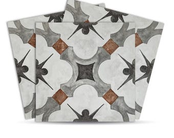 May include: A stack of square tiles with a repeating pattern. The design features gray, brown, and black geometric shapes on a white background. The tiles have a slightly distressed, watercolor-like appearance.