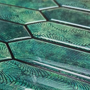 Macro close-up of glossy swirls and dark veining on emerald hexagon tiles, 3d vinyl backsplash tiles texture