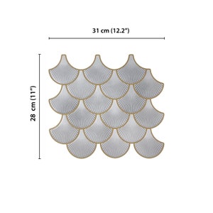 White 3D peel-and-stick tile with gold-edged scallop pattern, perfect kitchen backsplash and wall decor.