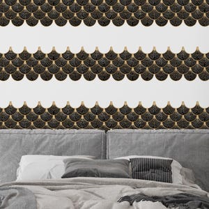 Black Egyptian peel-and-stick tile set in overlapping scallop shapes with tan borders for a 3D vinyl backsplash.