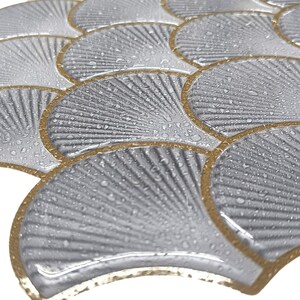 White 3D peel-and-stick tile with gold-edged scallop pattern, perfect kitchen backsplash and wall decor.
