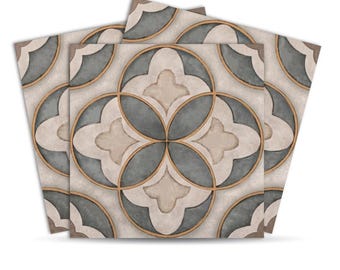 May include: Four square tiles with a repeating floral pattern. The design features a light beige background with gray and beige floral shapes, outlined in gold. The tiles are slightly angled, showcasing the pattern.