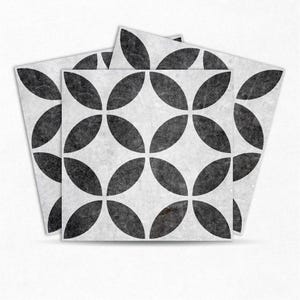 May include: Three black and white patterned floor tiles with a geometric design of overlapping circles. The tiles are made of a textured material and have a distressed look.