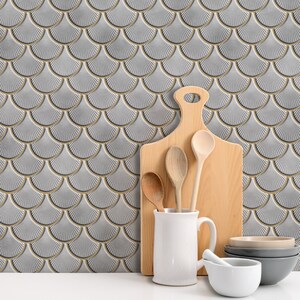 White 3D peel-and-stick tile with gold-edged scallop pattern, perfect kitchen backsplash and wall decor.