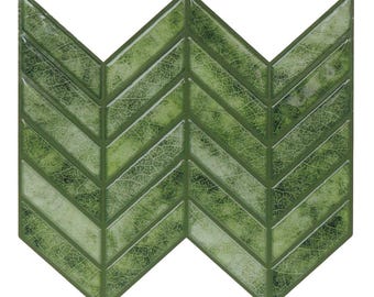May include: Green chevron-patterned tile with a leaf-like texture. The tile's design features a series of angled, rectangular pieces arranged in a zigzag pattern. The color palette includes shades of green, creating a natural, organic aesthetic. Ideal for kitchen backsplashes or bathroom walls.