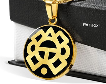 May include: Gold necklace with a black and gold pendant featuring a geometric design. The pendant is round and has a brushed finish. The necklace is on a black box with the text "FREE BOX!" printed on it.
