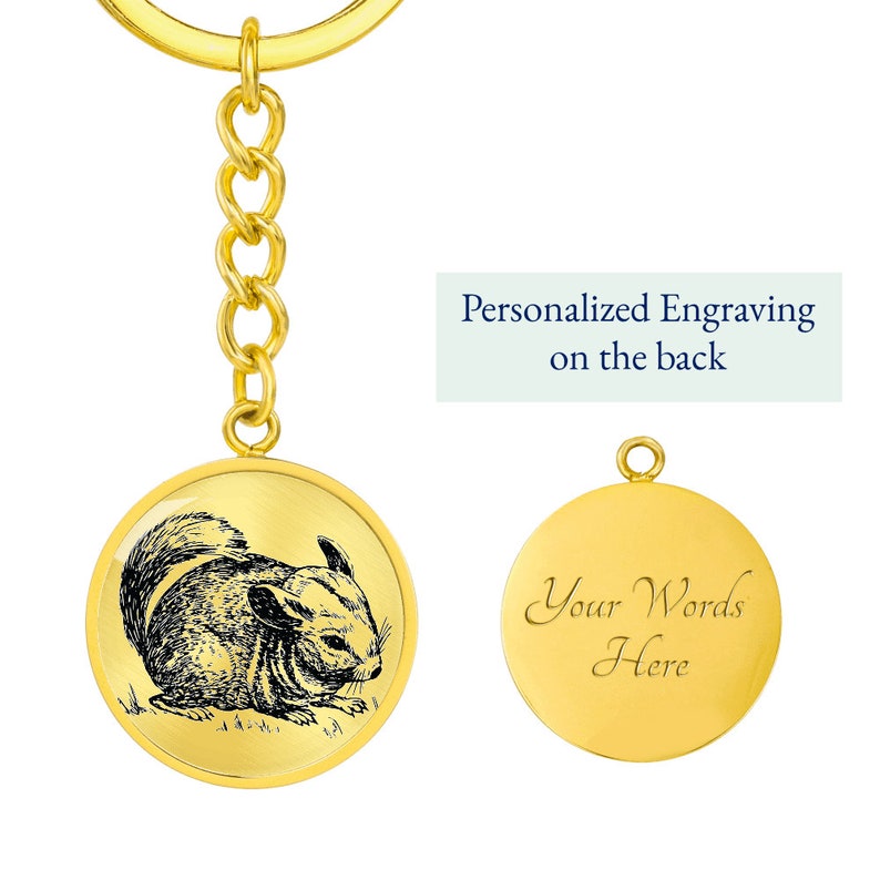 May include: Gold-tone keychain featuring a black and white illustration of a chinchilla on the front. The back of the keychain is blank and can be personalized with an engraved message. "Your Words Here" is shown as an example.