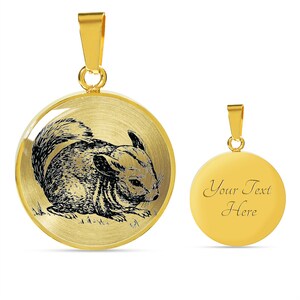 May include: Gold-tone pendant necklace featuring a detailed illustration of a chinchilla. The back of the pendant is blank and can be personalized with text.