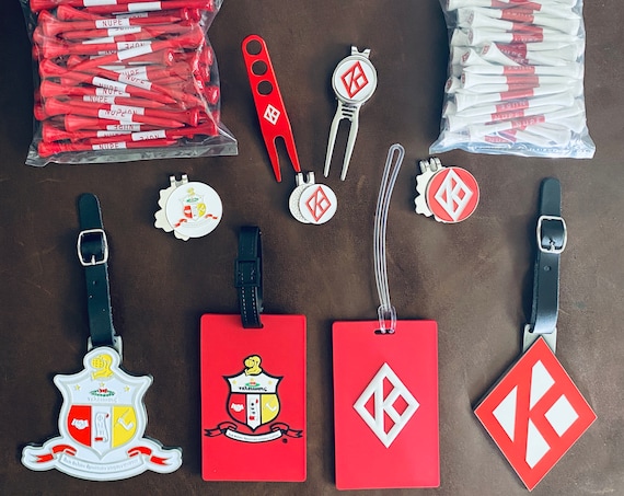 Nupe - The 'None Greater' package - includes items shown: 2 plastic bag tags, 2 metal bags, 3 ball markers, 2 divot tools, & 2 bags of tees
