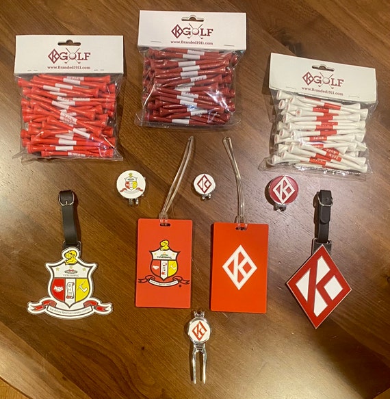 Nupe - The 'None Greater' package - includes items shown: 2 plastic bag tags, 2 metal bags, 3 ball markers, a divot tool, & 3 bags of tees