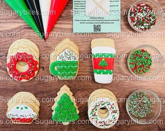 May include: A set of six Christmas-themed sugar cookies decorated with icing and sprinkles. The cookies are shaped like a donut, a coffee cup, a Christmas tree, a cupcake, a coffee cup, and a donut. The cookies are arranged on a wooden surface with bowls of sprinkles and piping bags.