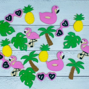 May include: A set of pink and green sugar cookies decorated with various tropical themes, including flamingos, palm trees, pineapples, and sunglasses.