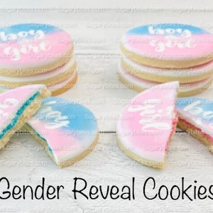 May include: Gender reveal cookies decorated with blue and pink icing and the words "boy" and "girl".