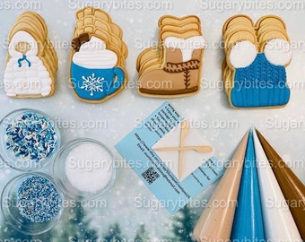 May include: A set of four decorated sugar cookies, including a snowman, a boot, a hot chocolate mug, and a winter hat. The cookies are arranged on a white surface with sprinkles, sugar, and piping bags.