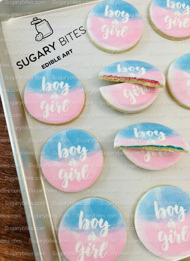 May include: A set of six decorated sugar cookies with a blue and pink watercolour design. The cookies are decorated with white icing and the text "boy or girl".