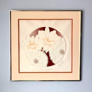 May include: Framed white paper art print with a red circle background featuring a white flower design. The print is titled "Sweet Surrender" and signed by the artist.