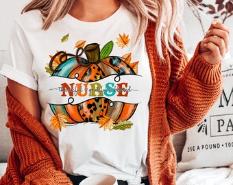 May include: White t-shirt with a colorful pumpkin design and the text "NURSE thankful & grateful & blessed".