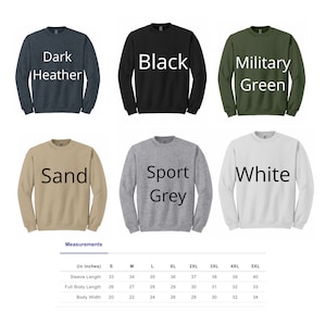 May include: A chart showing the different colors and sizes of a sweatshirt. The colors are dark heather, black, military green, sand, sport grey, and white. The sizes are S, M, L, XL, 2XL, 3XL, 4XL, and 5XL. The chart also includes measurements for sleeve length, full body length, and body width in inches.