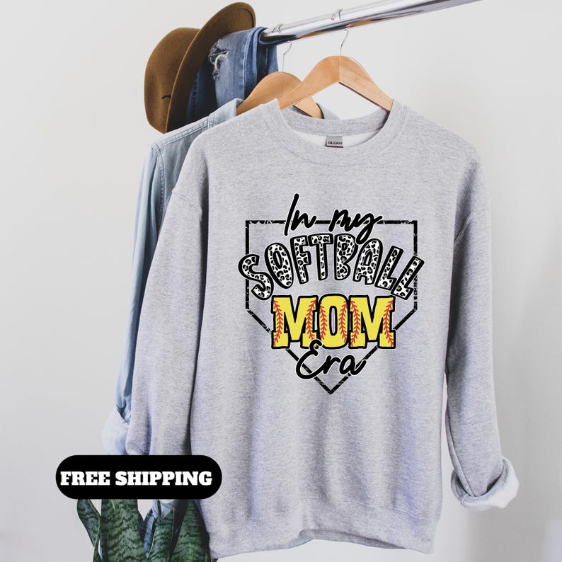 May include: Gray sweatshirt with a black and white softball graphic that says "In my Softball Mom Era".