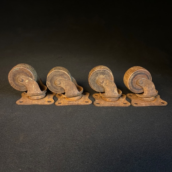 Antique salvage wood wheel casters with iron mounts, and ball bearing swivels.