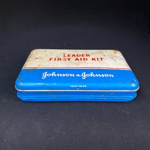 Antique Johnson and Johnson leader first aid kit tin with supplies included inside.
