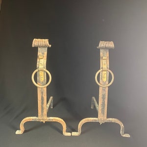 Hand forged wrought iron andirons with brass fixtures.