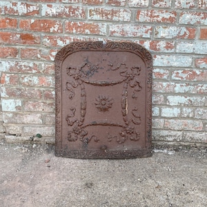 Antique Architectural and Salvage cast iron fireplace cover.