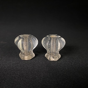 May include: Two clear glass cabinet knobs with a fluted design.