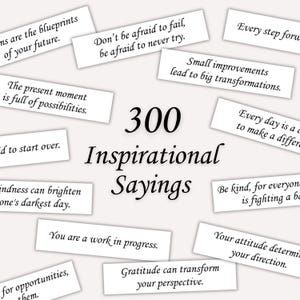 May include: A collection of 300 inspirational sayings printed on white cards. The cards are scattered on a white background. The text on the cards includes phrases like "Don't be afraid to fail, be afraid to never try." and "Every day is a chance to make a difference."