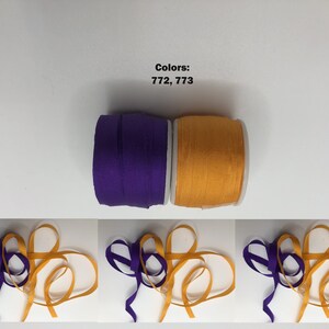May include: Two spools of ribbon, one purple and one orange. The spools are labeled with the colors 772 and 773. Three images show the ribbon tied in a bow.