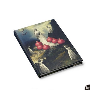 May include: A dark blue journal cover with a collage of a woman in a white dress standing on a rocky landscape with red pomegranates. The woman is surrounded by other figures in white dresses. The journal cover has a vintage aesthetic.