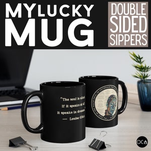 May include: Black ceramic mug with a white quote on one side that reads "The soul is silent. If it speaks at all it speaks in dreams. - Louise Gl&uuml;ck" and a colourful illustration on the other side. The mug is on a wooden table.