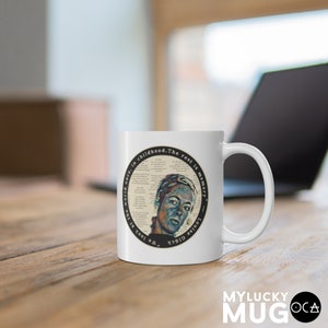 May include: White ceramic mug with a black circle design featuring a portrait of a person with a quote from Louise Gl&uuml;ck: "We look at the world once, in childhood. The rest is memory."