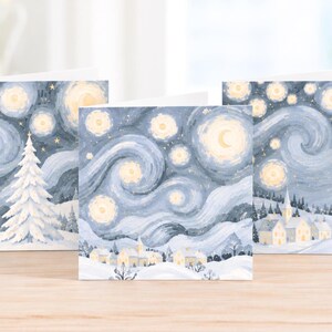 Pack of three Van Gogh inspired Christmas cards featuring snowy winter scenes with swirling blue skies and warm golden stars.
