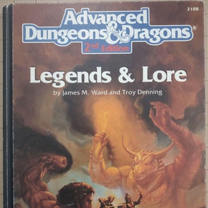 May include: A book cover for the Dungeons & Dragons game, 2nd Edition, titled "Legends & Lore" by James M. Ward and Troy Denning. The cover features a fantasy illustration of a muscular man with a laurel wreath, a minotaur, and a sword fight.