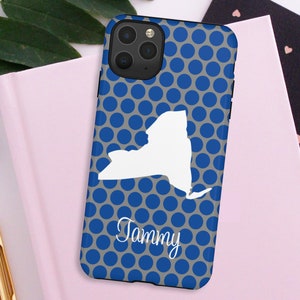 May include: A blue and gray phone case with a white outline of the state of New York and the name "Tammy" printed on it. The case has a polka dot pattern.