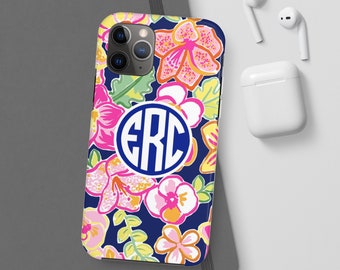 May include: A navy blue phone case with a floral pattern in pink, yellow, and white. The case has a white circle with the monogram "ERC" in blue letters.