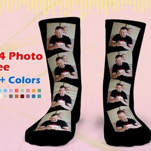 May include: A pair of black socks with a photo collage design. The socks feature four photos of a man and a child. The text "1~4 Photo Free 20+ Colors" is displayed on the image.